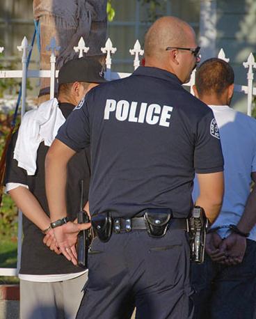LAPD officer arresting young Latino men