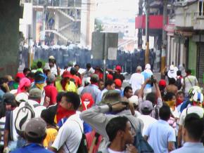 The contingent of campesinos and indigenous Hondurans march past a police line